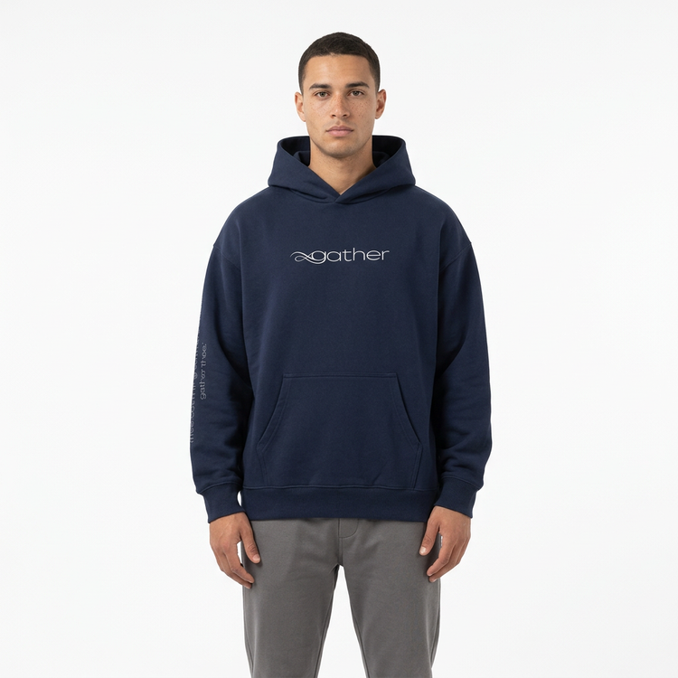 Model wearing the Gather Essential Hoodie in navy blue on a white studio background