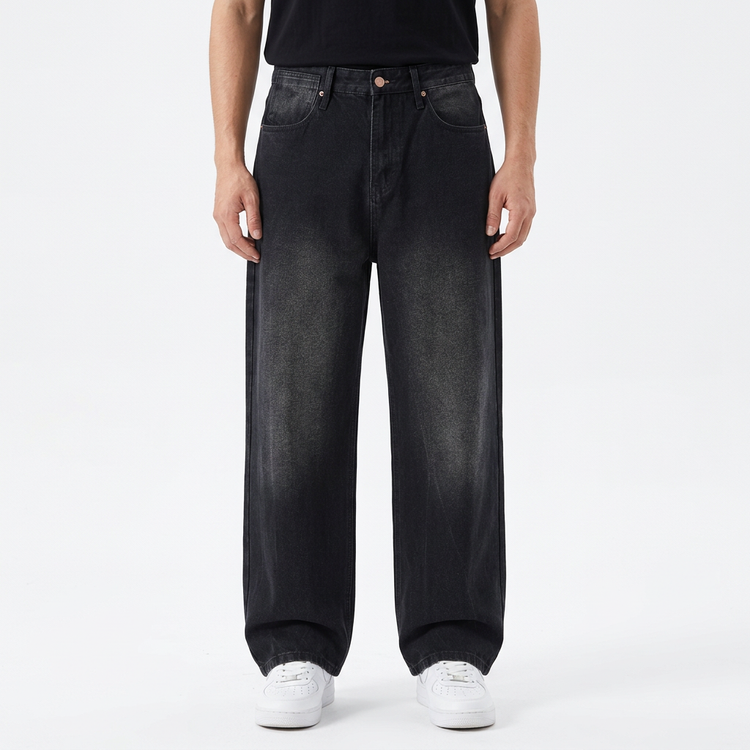 Model wearing Men's Gather Vintage Wash Jeans in black wash on a white studio background